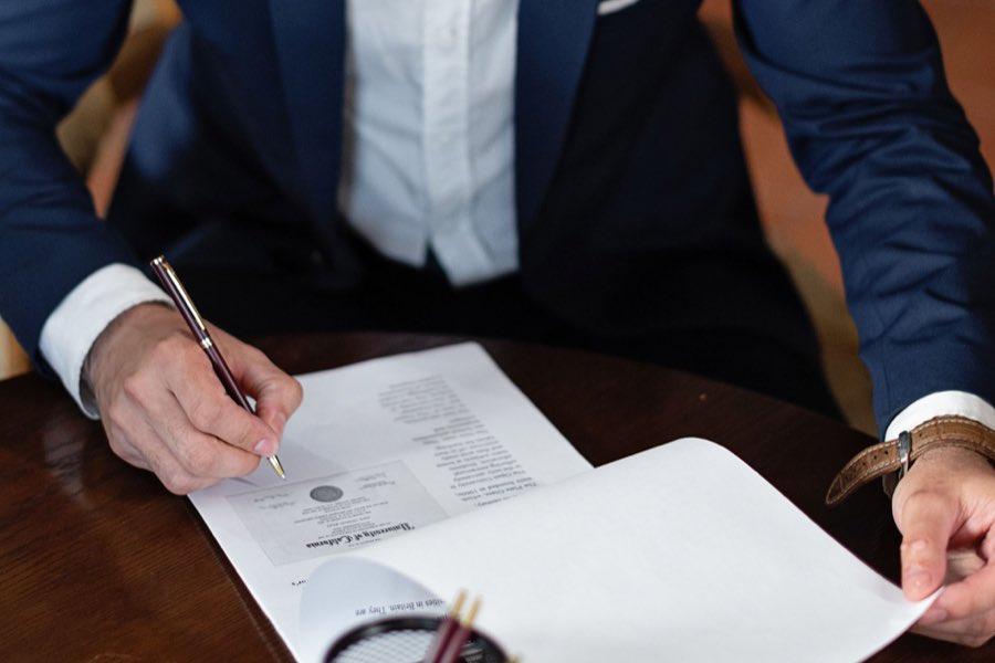 Counsel signing an agreement with a fountain pen